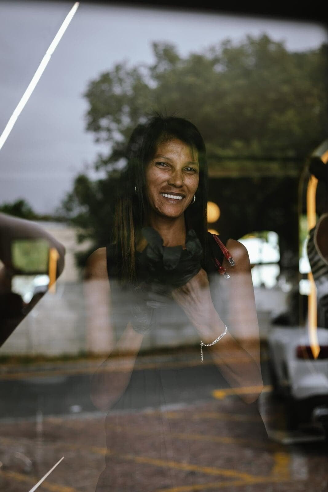 An image of Lucinda smiling through the window.