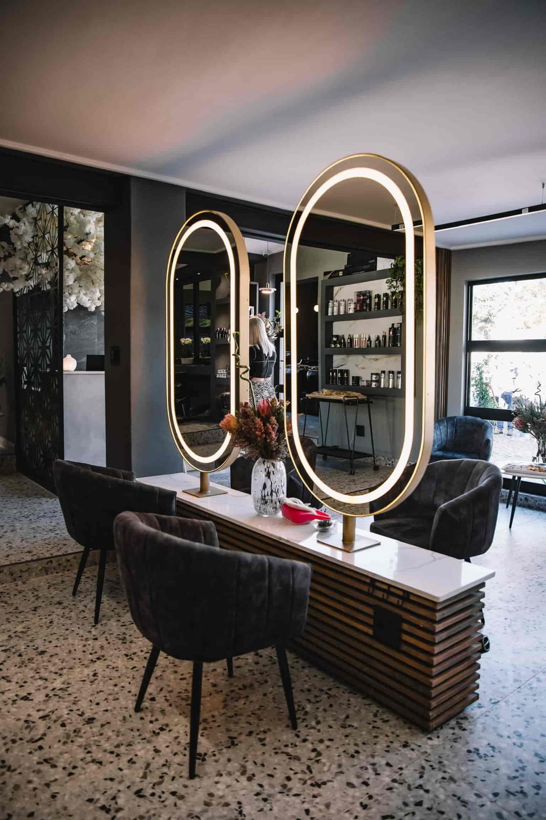 Image of salon chairs with large mirrors.
