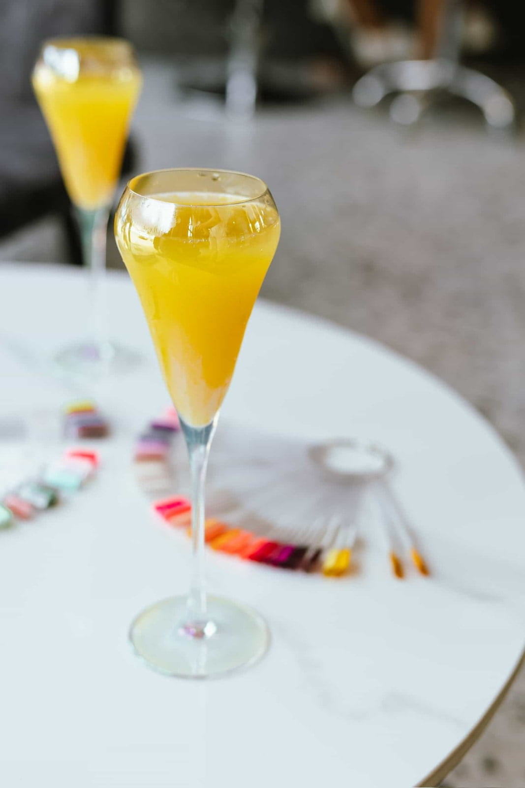 Image of a mimosa next to nail extensions