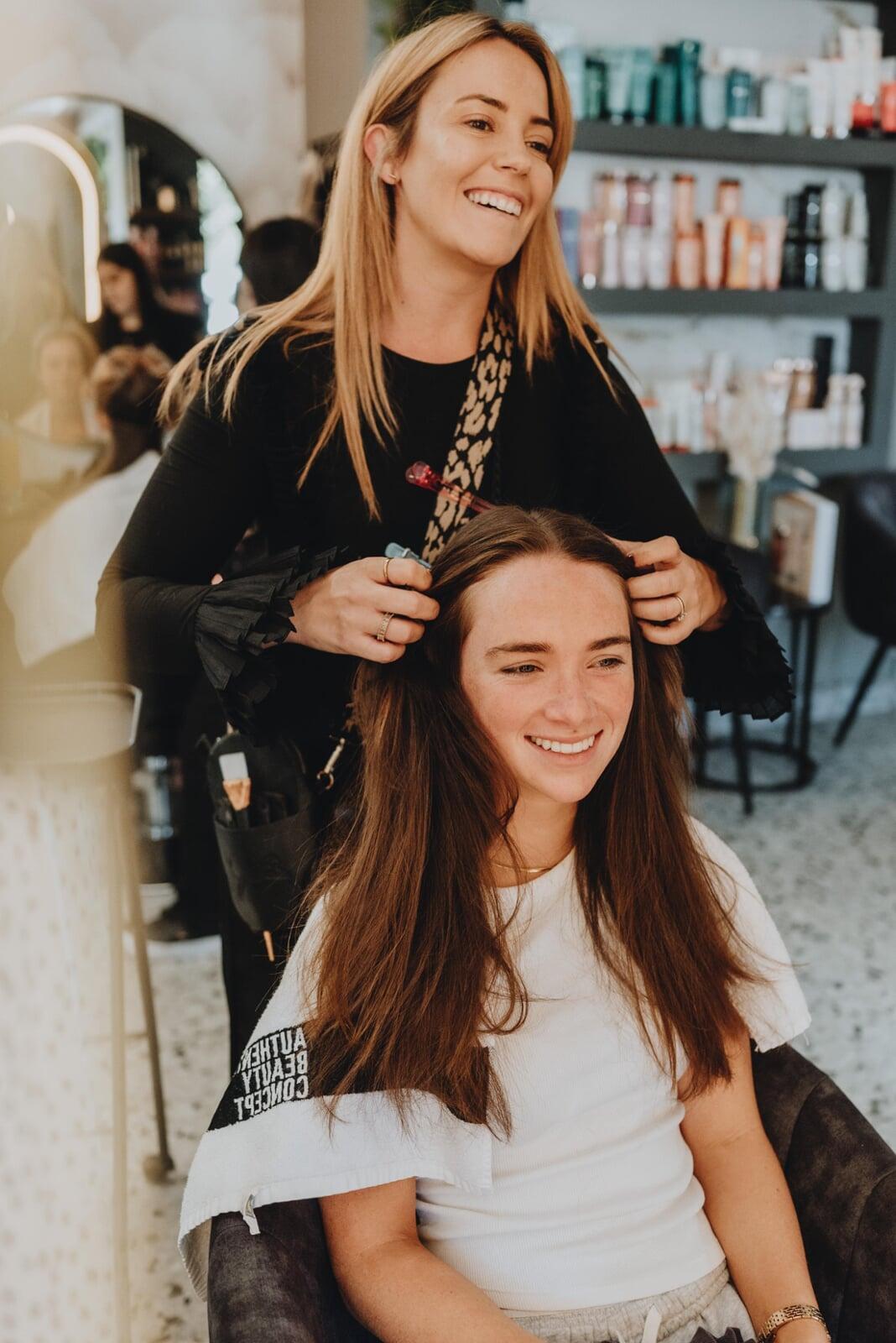 An image of Lucinda smiling through the window.