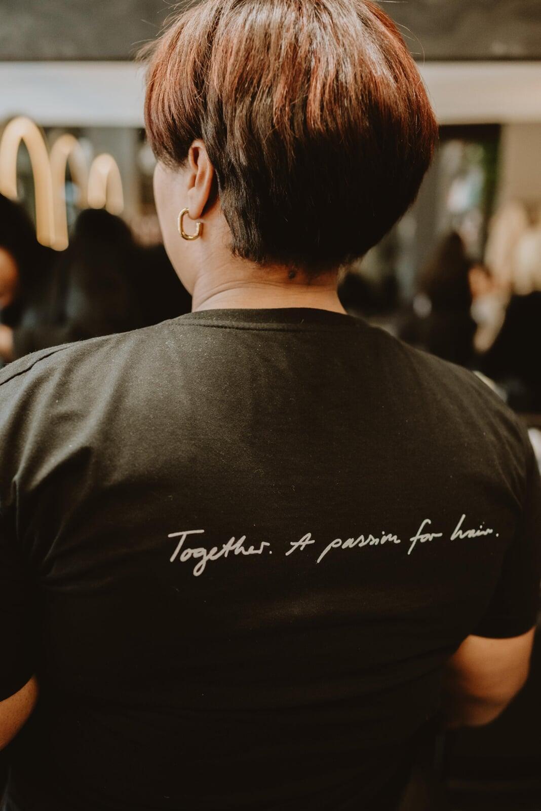 A client smiling and getting her hair cut.
