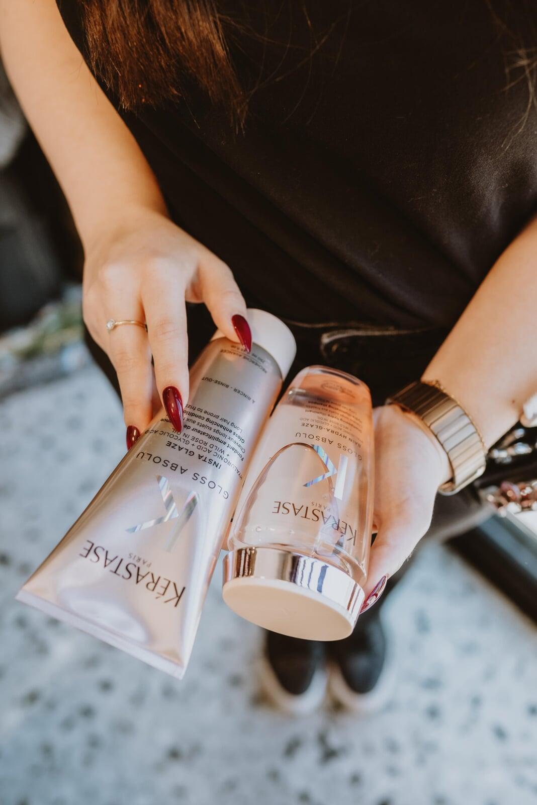 An Image of a man getting a pedicure and his hair trimmed.